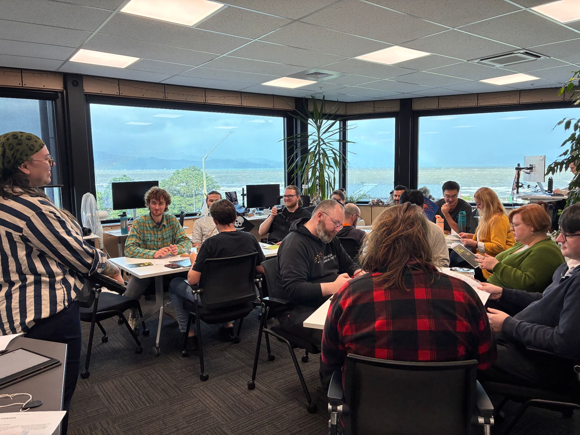 A Leadership Treehouse session in full swing, leaders gathered around tables with cards and dice
